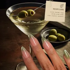 A dirty martini, but for your nails. This design features olive chrome tips on a milky pink nude base, with tiny crystal accents for a touch of class.