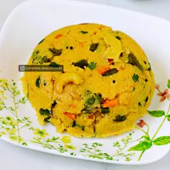 This is our Khara Bath, a savory semolina dish cooked with mixed vegetables, spices, and topped with cashews. It's a comforting and wholesome breakfast item that is a staple in South Indian cuisine.