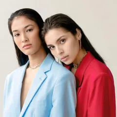 Two shades, one bond. A conceptual fashion portrait exploring contrast and connection, with two models in bold red and blue blazers creating a single, powerful image.