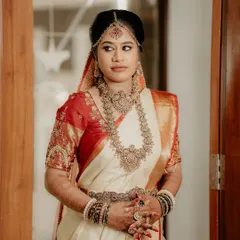 A classic bridal portrait. The bride's pose and expression exude grace and elegance, capturing a moment of quiet contemplation before the ceremony.