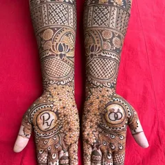 A lovely engagement mehendi design featuring the couple's initials and engagement rings within a floral mandala. It's a beautiful way to celebrate the beginning of a new journey.