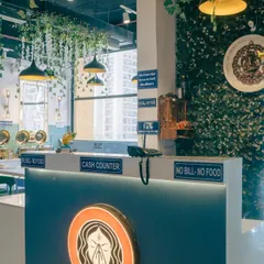 My cash counter, where you'll always be greeted with a smile. The lit-up logo and clean design are part of the professional yet welcoming atmosphere.