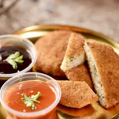 A detailed shot of the Chicken Minced Cutlet, showing the perfectly breaded exterior and the soft interior. A classic comfort food appetizer for any event.
