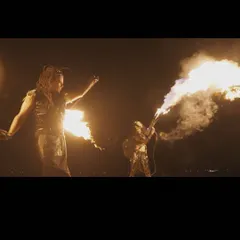 A dramatic shot of our duo show, with one performer using a flamethrower while the other spins fire. This highlights the scale and impact of our group acts.