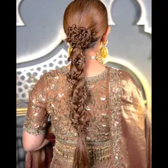 The full view of this stunningly complex braid, perfect for a bride wearing a traditional outfit with an open-back blouse to show off the hair artistry.