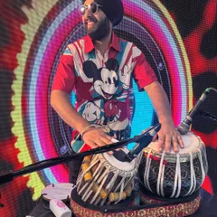 A cool shot of me on stage with my tabla, ready to perform. The Mickey Mouse shirt shows my fun side.