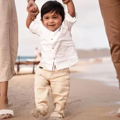 Taking his first steps on the sand with help from mom and dad. We love to document these incredible milestones during our outdoor family beach sessions.
