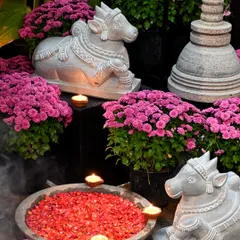 During a festival, our stone Nandi statues and stupas are arranged with flowers and diyas, creating a beautiful display of our handcrafted decor.