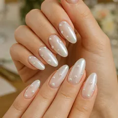 A perfect example of subtle bridal luxury. These almond-shaped nails feature a soft, pearlescent finish with delicate pearl embellishments for an elegant and timeless look.