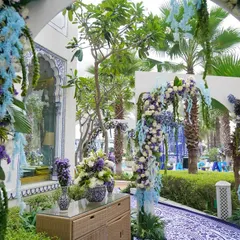 The entrance to the celebration, with arches adorned in cascading blue and white florals, leading guests into the beautifully themed space.