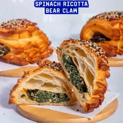 The Spinach Ricotta Bear Claw is a classic savoury pastry. The creamy spinach and ricotta filling is encased in a beautifully shaped, flaky croissant dough.