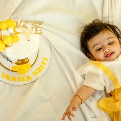 A close-up of the half-birthday girl and her personalized cake, capturing her sweet expression.
