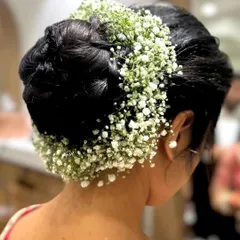 Another angle of the beautiful floral bridal bun. This style keeps the hair neatly off the face while looking incredibly graceful.