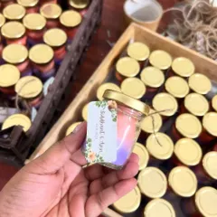 A close-up of a mini scented candle for Siddhant and Ann's wedding. The two-tone ombre wax is a simple way to add a beautiful custom touch.
