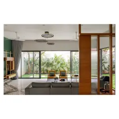 The living areas in the 'Solid Void Solid' house are designed as open, fluid spaces that connect directly to surrounding gardens. We used large glass panels and a neutral color palette to enhance the sense of spaciousness and draw the verdant landscape into the home's interior.