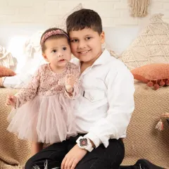 A protective big brother with his baby sister. Capturing these sibling relationships is one of our favorite things.