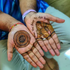 This groom's henna is so special! It features a portrait of his bride on one hand and a mandala with the word 'Mehak' (fragrance) on the other.