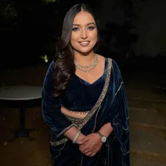 A beautiful smile from a happy client. This full-length shot shows how the bronze makeup and old-hollywood waves come together for a truly regal sangeet night look.
