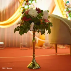 This elegant floral arrangement on a tall, golden stand adds a touch of sophistication to the stage area or as a floor accent. The mix of white and red flowers provides a classic color combination suitable for any celebration.