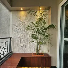 This wider view shows how the sculptural art piece transforms the balcony into a sophisticated outdoor living area. It serves as a permanent, weather-resistant feature wall.