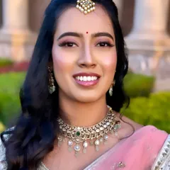 Keerthi's reception makeup showcases a beautiful, dewy highlight on the cheeks that catches the light and gives a youthful glow.