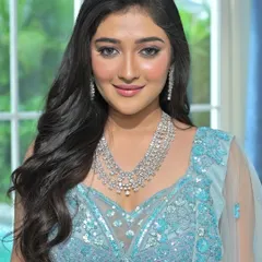 The model looks radiant in this close-up, showcasing the brilliance of the multi-layered Zircon necklace.