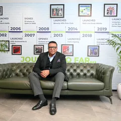 A portrait of a CEO in his office, with a timeline of the company's history in the background. This is a powerful way to visually tell the story of a brand's journey and success.