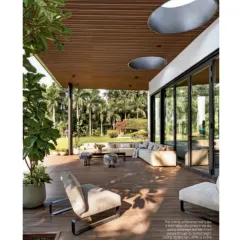 This view shows how the outdoor lounge area is designed for relaxation and conversation. The furniture is low-profile and comfortable, ensuring that the focus remains on the expansive garden views.