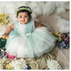 This little one, dressed in a lovely seafoam green dress, sits happily in a dreamy cloud and flower setup. Sitter sessions are perfect for capturing babies once they can sit up independently.