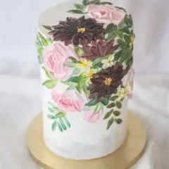 I love playing with moody color palettes. The deep burgundies and pinks against the marbled grey frosting give this tall floral cake a sophisticated and artistic feel, perfect for an elegant celebration.