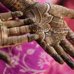 The intricate details of my bridal mehendi, with my husband's name hidden in the design. These small personal touches are what make a wedding so special.