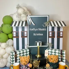 A full view of the sophisticated hamper for the Ambani twins, with two teddy bears, personalized name plaque, and stylish patterned gifts.