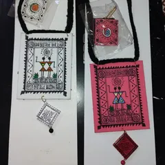 Showcasing two color variations of my Warli art necklace sets. Whether you prefer the classic black-on-white or the vibrant pink-and-red, each piece is hand-painted with care. This image shows how the same design can offer a different feel depending on the color palette.
