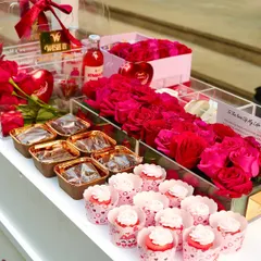 The delicious treats at our Valentine's stall, including cupcakes, brownies, and boxes of beautiful red roses.