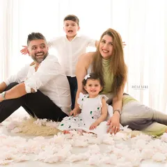 A playful family photo where everyone is relaxed and having fun. It captures the real, joyful chaos of family life.