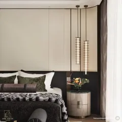 A close-up on the bespoke bedside setup, featuring a marble-topped nightstand and elegant pendant lights. This detail highlights our focus on combining high-end materials with functional, beautiful lighting design.