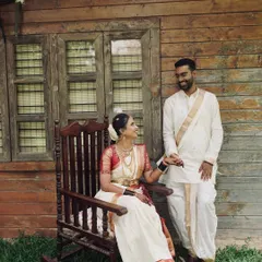 A beautiful, quiet moment between the couple during their pre-wedding shoot. Her traditional makeup looks flawless and elegant in this rustic, natural setting.