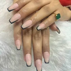 A modern and sharp take on the classic French manicure. We used long, coffin-shaped acrylic extensions with a clean nude base and a striking black tip to create a sophisticated, high-fashion statement.
