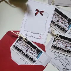 Farewell tokens for the Class of 2025. These cards feature a group photo and a space for a handwritten note, all tucked into a classic red envelope.