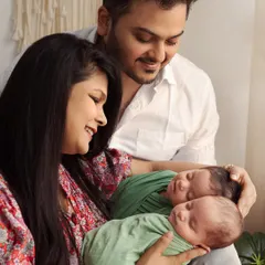 The complete family portrait. In this studio shot, we have Mumma and Papa holding their newborn twins, all together in one frame. I guide my clients into comfortable, natural poses that show their connection.