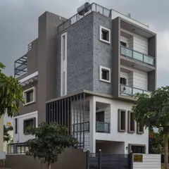 This completed home features a bold facade with dark slate cladding and strong vertical lines. The design demonstrates how I use contrasting materials and forms to create a powerful architectural statement.