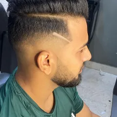 Modern grooming is about personal style. This high fade is accented with a sharp, razored line, adding a custom touch that makes the haircut unique while keeping the overall look clean and professional.