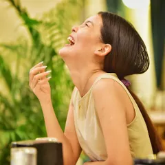 A moment of pure, uninhibited laughter during a cafe visit. This candid shot captures the joy and fun of spending time with loved ones (and their pets).