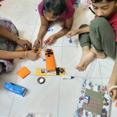 Teamwork makes the dream work. Students collaborate during a summer camp session, carefully assembling the components for a DIY metal detector.