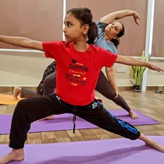 Yoga is a powerful tool for children. In my kids' classes, we work on asanas like Virabhadrasana II (Warrior II Pose) to build real strength, improve concentration for school, and develop a calm mind. We make it fun so they build habits for life.