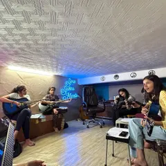 A wide view of our guitar class in session. The comfortable, informal setting helps students relax and learn without pressure.