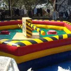 This is our Eliminator inflatable game. It's a competitive obstacle course where players have to jump and duck rotating arms, perfect for bringing high energy to corporate offsites or large parties.