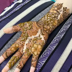 This non-bridal design uses bold floral and leaf motifs to create a striking pattern across the hand.