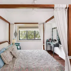 For Aditi Rao Hydari's home, the bedroom is a serene escape. A four-poster bed with light, airy curtains creates a dreamy focal point. The space is kept simple and elegant, with a focus on comfort and tranquility.