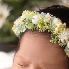 A detailed shot of a beautiful floral headband on a baby's head. I use high quality, soft accessories that are perfectly sized for newborns.